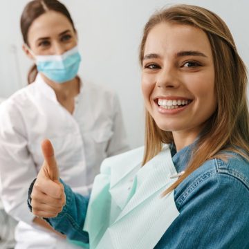 femme contente de sa visite à la clinique dentaire